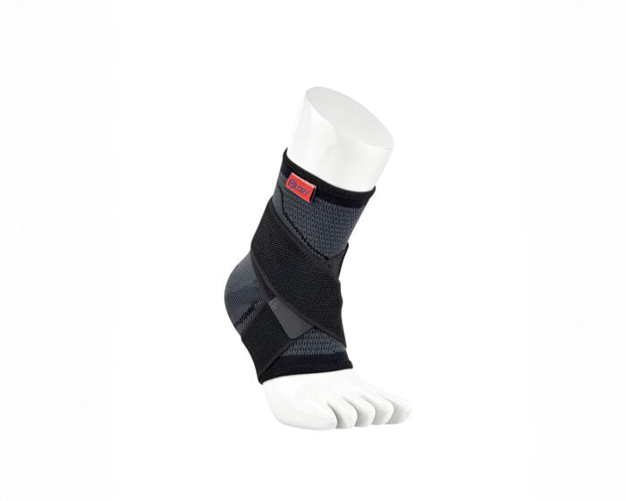 Black ankle brace with red and black logo on mannequin foot